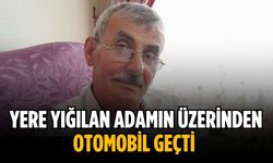 Yere yığılan adamın üzerinden otomobil geçti