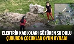 Elektrik kabloları gözüken su dolu çukurda çocuklar oyun oynadı