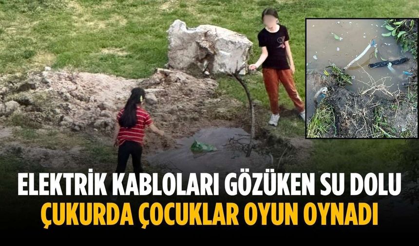 Elektrik kabloları gözüken su dolu çukurda çocuklar oyun oynadı